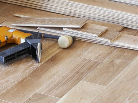 Tools and wooden flooring planks ready to be installed