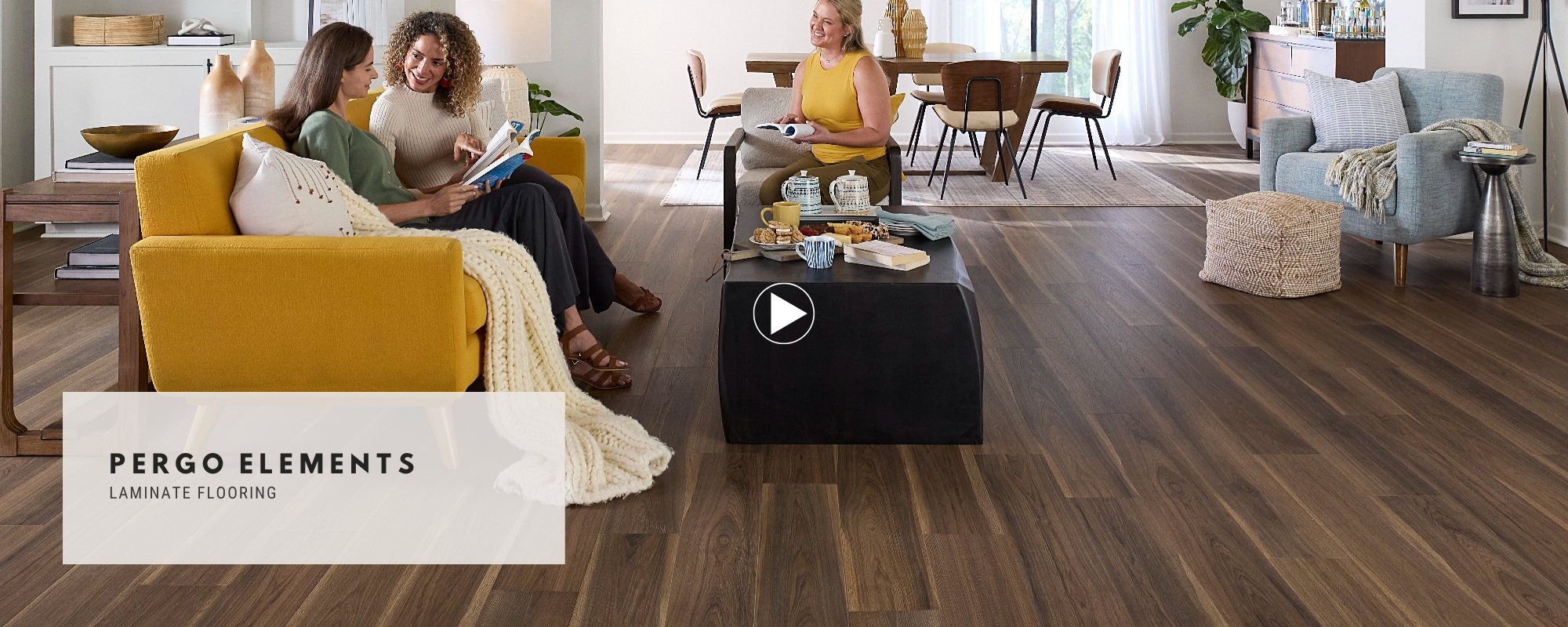 Three women sitting in a stylish living room with durable Pergo flooring